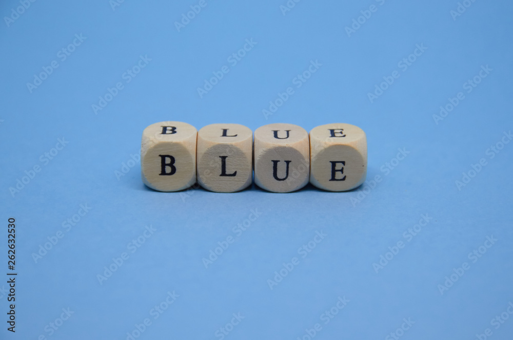 blue word built with wooden cubes and black letters on the floor and blue background blue word built with wooden cubes and black letters on the floor and blue background