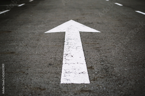 Arrow Sign on Asphalt Road