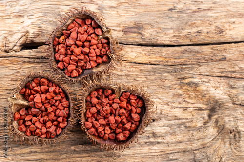 Annatto seeds on rustic wood