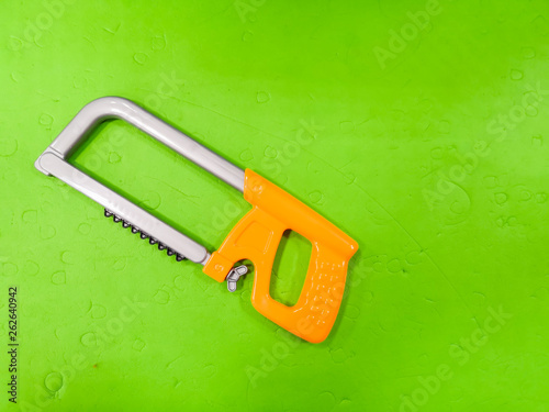 Children's bait, on a green background. Tool for the child, repairman detsky, development for children, preparing the child for adult life. photo