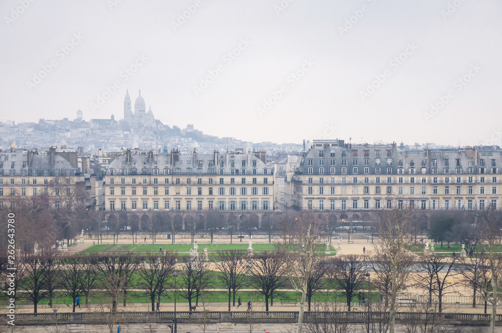 View from the height of the Tuileries garden and the temple on a hill in the fog