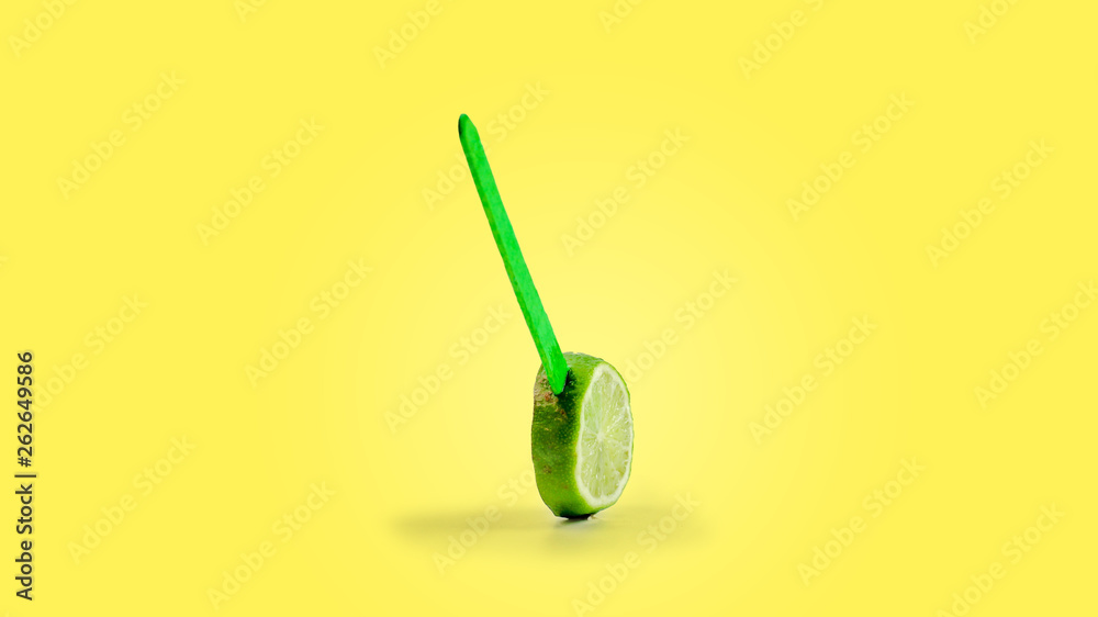 sliced lemon fruit on a stick. yellow background sliced lemon fruit on a stick. yellow background