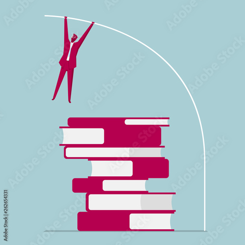 Businessman pole vaulted over books. Isolated on blue background.