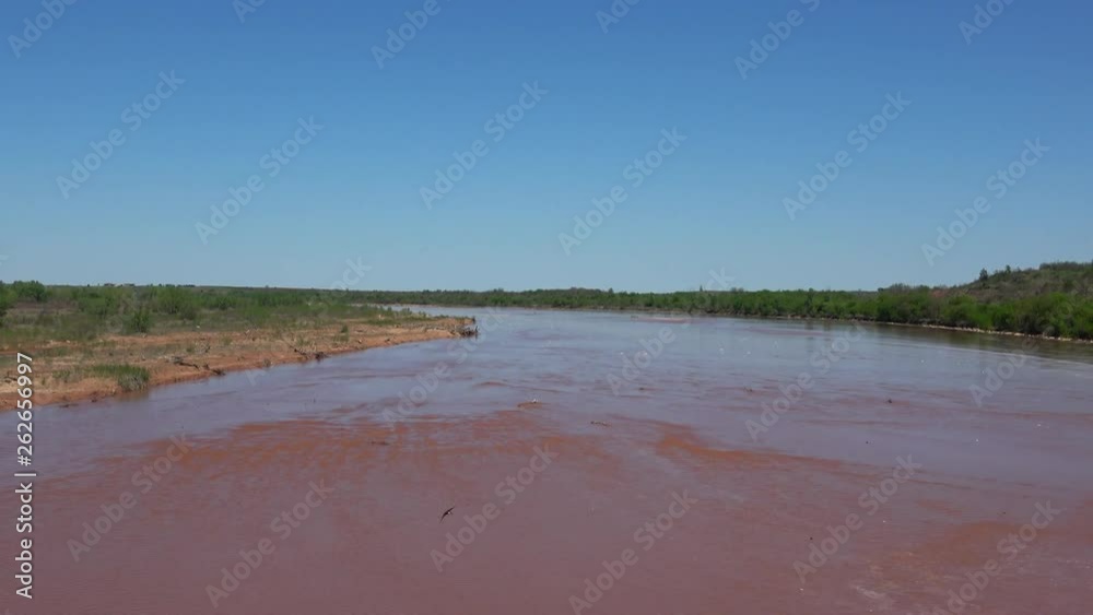 View of the Red river after a hard rain. View taken from a bridge leaving Texas into Oklahoma. View of the Red river after a hard rain. View taken from a bridge leaving Texas into Oklahoma.