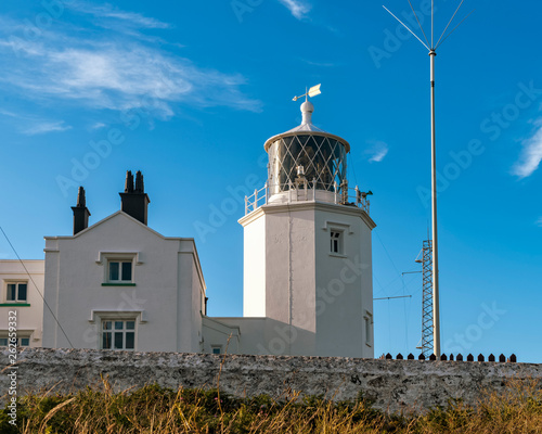 Lizard lighthouse at Lizard point in Cornwall. Copy space in blue sky. photo