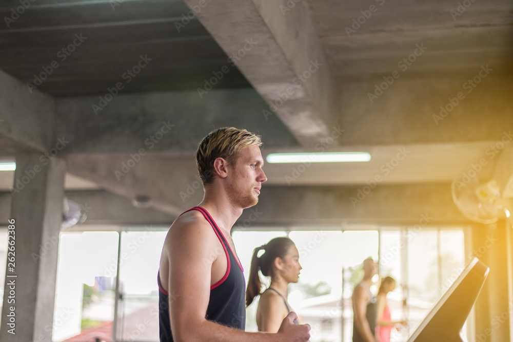 Man running on treadmills doing cardio training in a gym,Healthy lifestyle concept Man running on treadmills doing cardio training in a gym,Healthy lifestyle concept