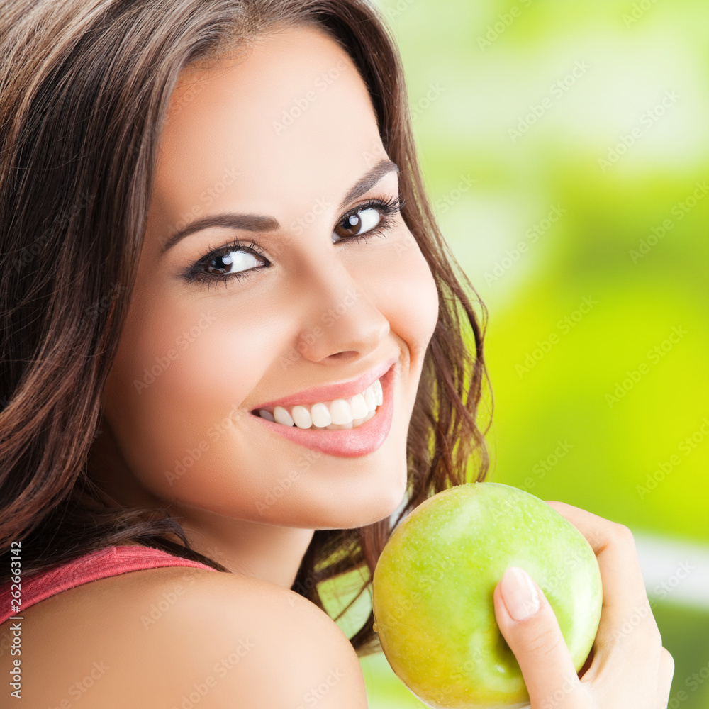 Young lovely woman with green apple, outdoors Young lovely woman with green apple, outdoors