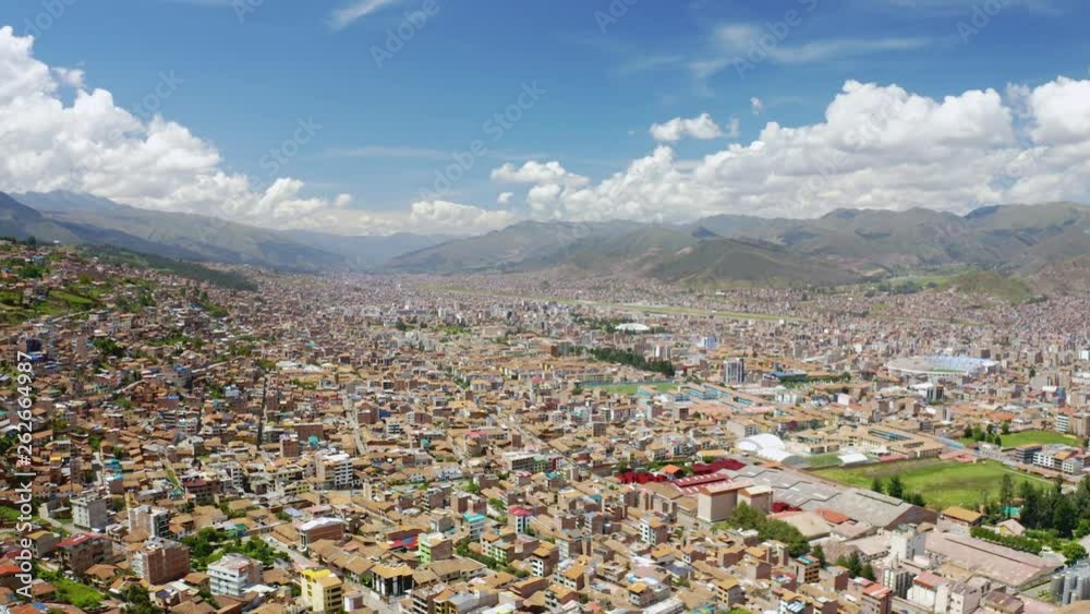 Aerial general view of Cusco city at daylight. Touristic destination in the Andes mountains of Peru. Panoramic angle depicting colonial city landscape and skyline with traditional houses.