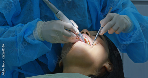 Woman under dental check up in clinic