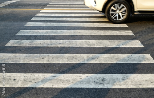 crosswalk on the road for safety when people walking cross the street, Pedestrian crossing on a repaired asphalt road, Crosswalk on the street for safety. 