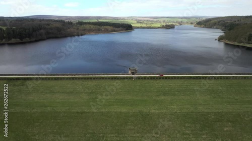 Aerial Flyover from Swinsty to Fewston Reservoir with Car Crossing Dam Inbetween photo