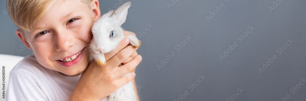 Little boy white Tshirt and tame dwarfish rabbit Little boy white Tshirt and tame dwarfish rabbit