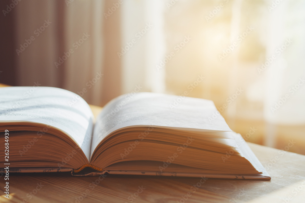open book on wooden table, morning light open book on wooden table, morning light