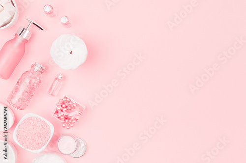 Girlish cute cosmetic products for bath on pastel pink background, top view, copy space.