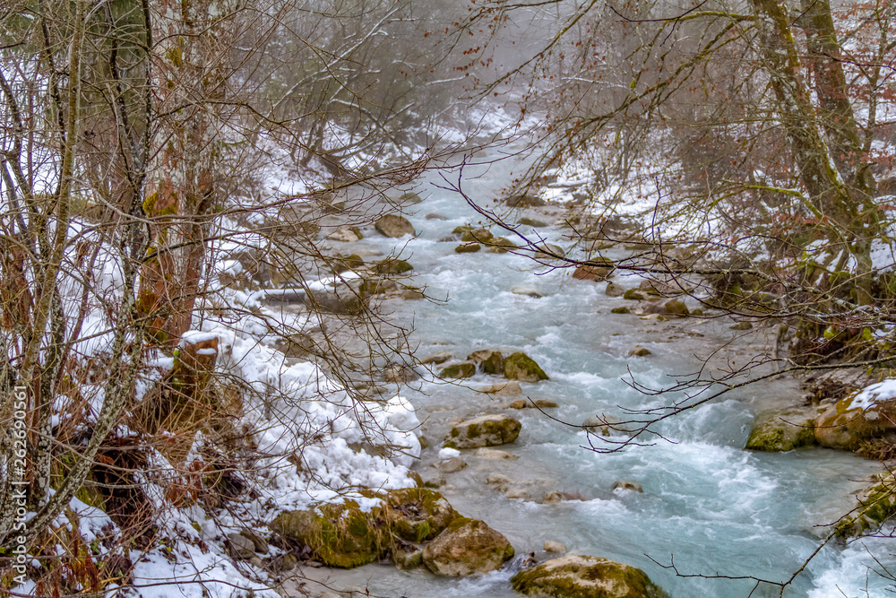 alpine stream at winter time