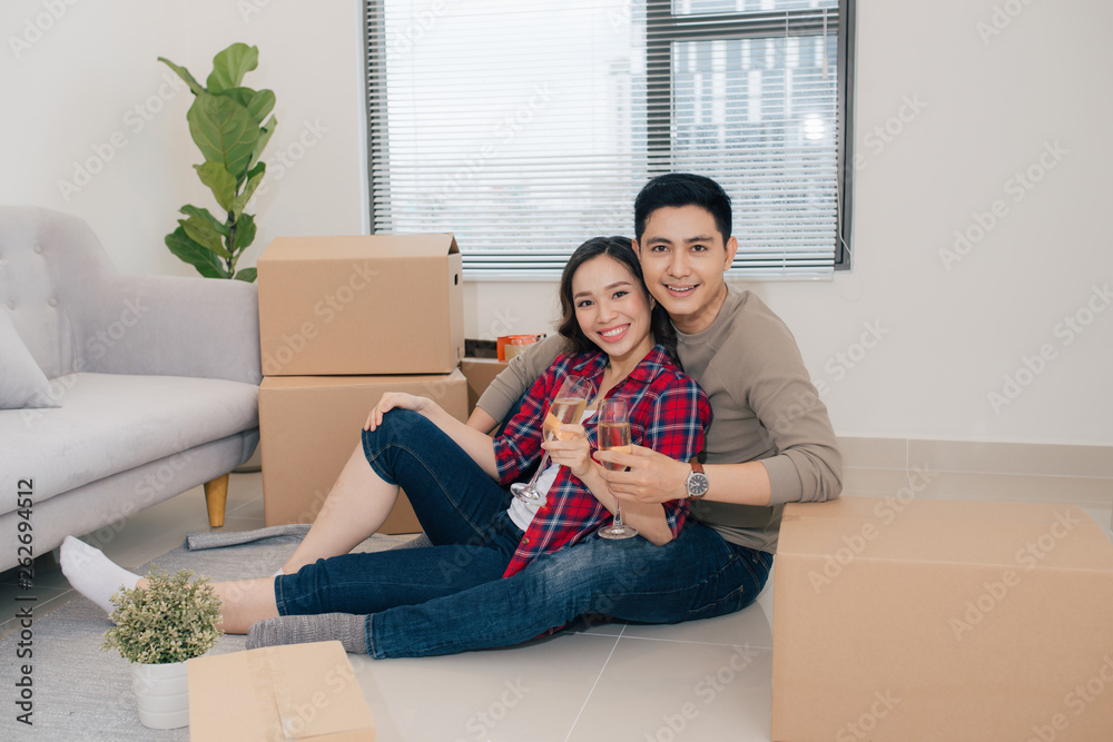 Just married couple of young man and woman feeling unbelievable chilling in their new house Just married couple of young man and woman feeling unbelievable chilling in their new house