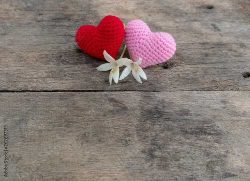 Knitting hearts with Millingonia on wooden table photo