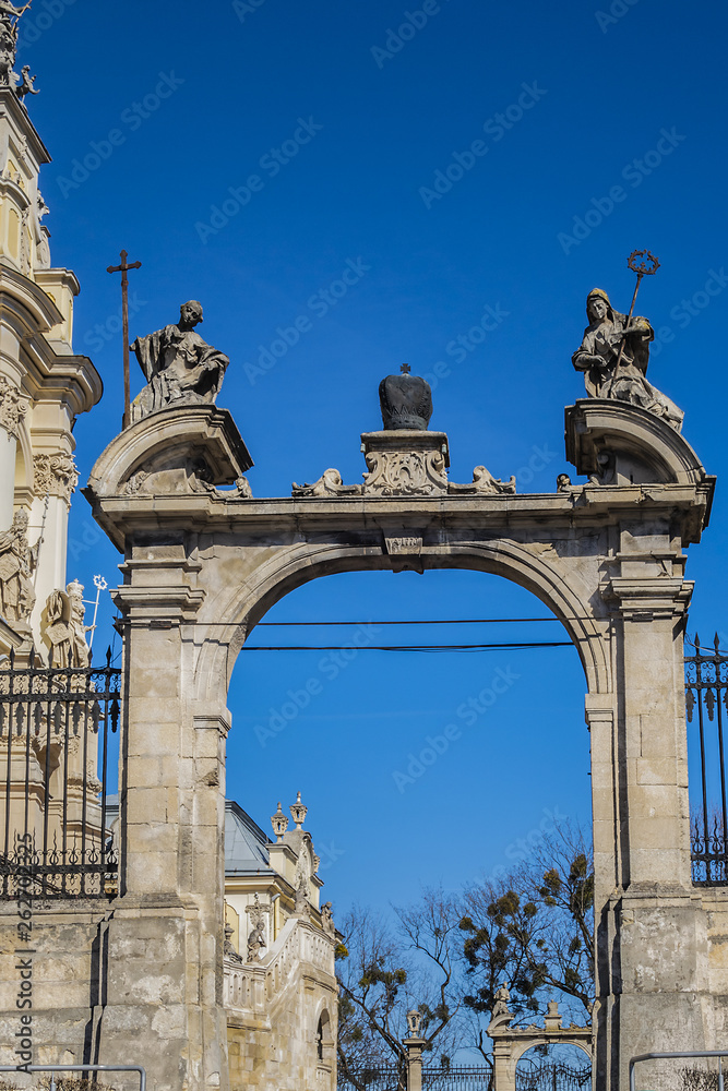 Double parade gate with baroque pediment and figures of saints to Lviv Greek Catholic Archbishop's Cathedral of Saint George (Ukr: Sobor sviatoho Yura, 1760). Lviv, Ukraine.