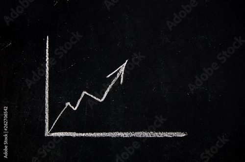 Growth chart drawn on black chalkboard.
