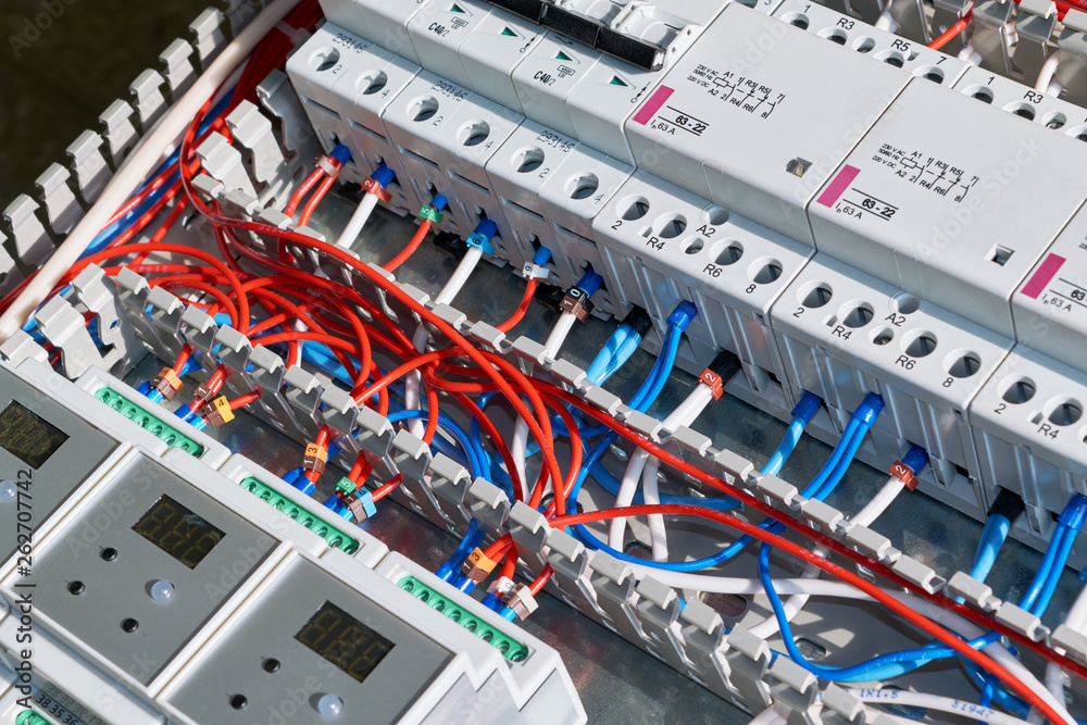 Laying of electrical wires in a perforated cable channel, connection to circuit breakers, contactors, controllers with display in the electrical Cabinet. Connection of wires according to the scheme. Laying of electrical wires in a perforated cable channel, connection to circuit breakers, contactors, controllers with display in the electrical Cabinet. Connection of wires according to the scheme.