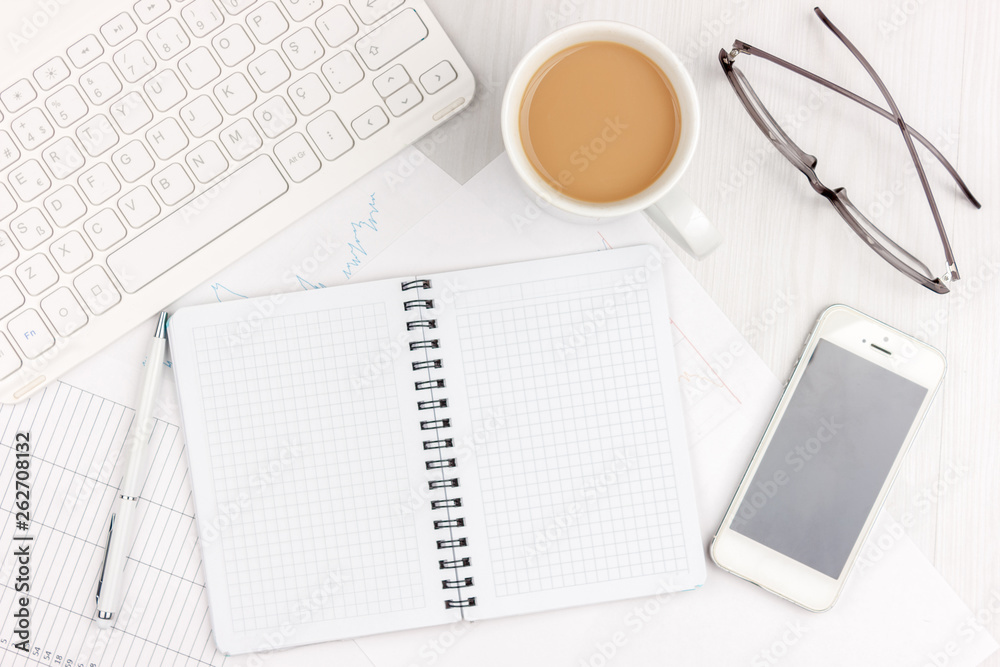 Flat lay photo of white office desk with laptop, smartphone, eyeglasses, notebook and pen with copy space background. Mockup Flat lay photo of white office desk with laptop, smartphone, eyeglasses, notebook and pen with copy space background. Mockup