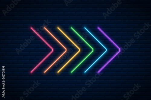 Photography Vector glowing neon arrow  on dark brick wall background.