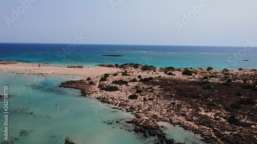 Elafonissi beach aerial shot with a surfer paragliding on this scenic wite sand beach located on the island of Crete, Greece photo