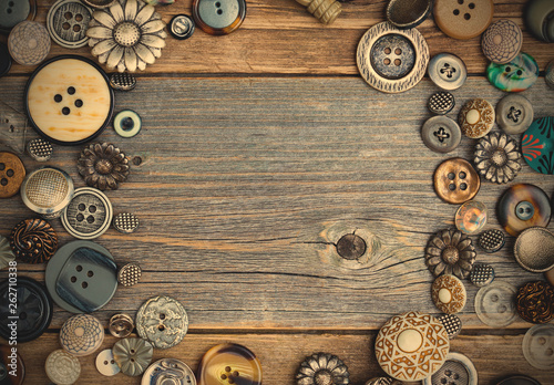 placer of vintage buttons with copy space on textured old boards