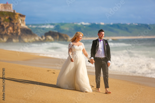 Beautiful wedding couple posing on beach