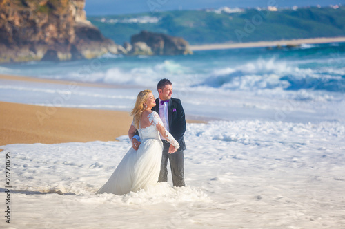Beautiful wedding couple posing on beach © hreniuca