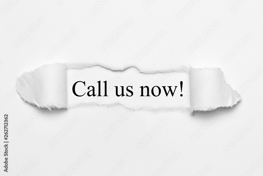 Call us now! on white torn paper Call us now! on white torn paper