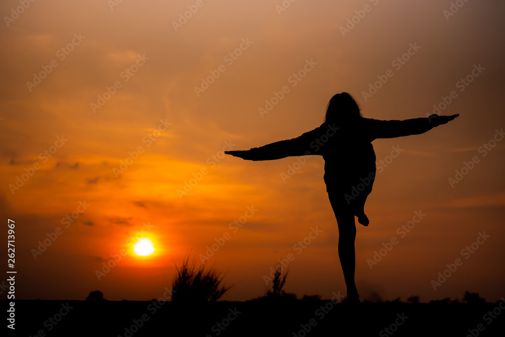 Silhouette Asia woman yoga on sunset. - Image