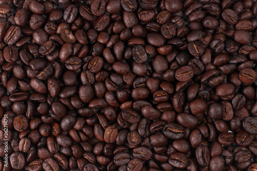 Roasted coffee beans, dark Roast coffee background. Closeup top view pile of coffee beans