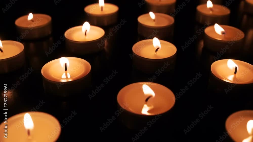 Candle Flames Slowly Sway. The flame of a multitude of candles is slowly swaying from the light wind. Filmed at a speed of 240fps Candle Flames Slowly Sway. The flame of a multitude of candles is slowly swaying from the light wind. Filmed at a speed of 240fps