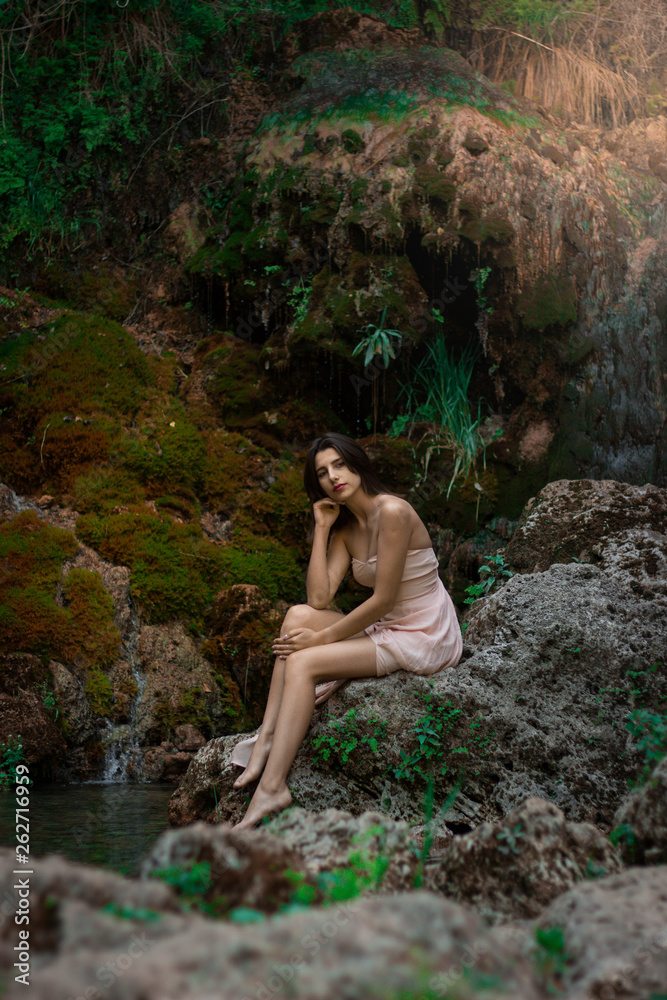 Beautiful girl posing in river. Fairytale story. Natural pool surrounded by green tree's leafs. Beautiful girl posing in river. Fairytale story. Natural pool surrounded by green tree's leafs.