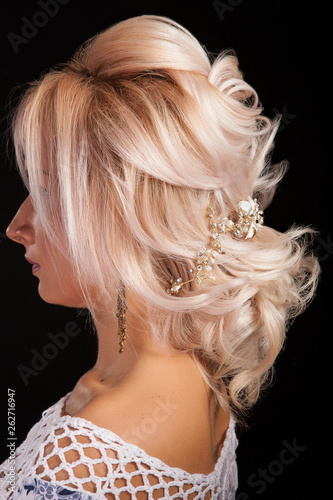 Close up shot of beautiful coiffure on a blonde woman isolated on black background
