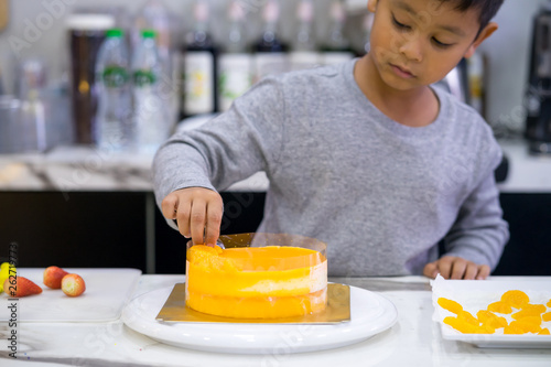 happy kid boy making a cake