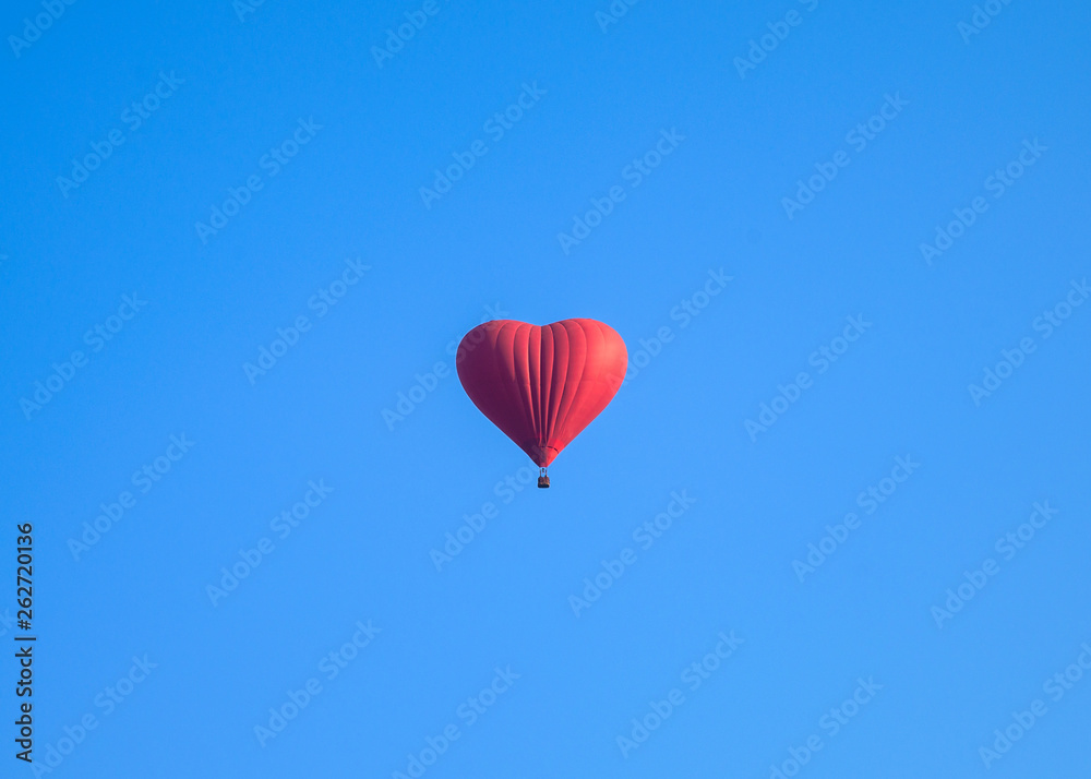 Fototapeta premium Colorful hot air heart shape balloons flying in blue sky
