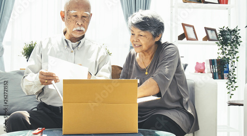 Asian senior man and woman open box with smile face.