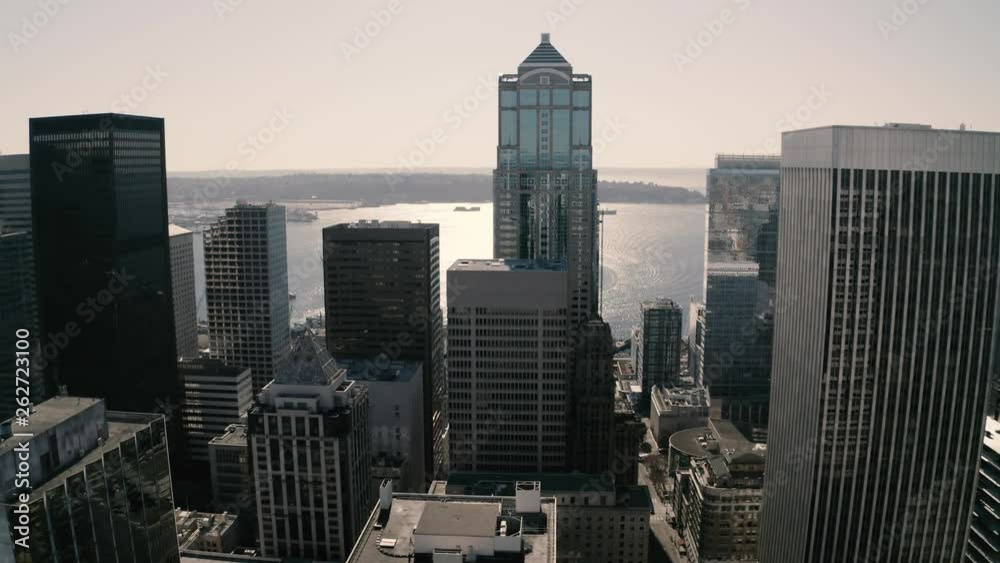 Seattle downtown, skyline with skyscrapers, highrise office and residential buildings with Elliott Bay waterfront and Puget Sound in the background Seattle downtown, skyline with skyscrapers, highrise office and residential buildings with Elliott Bay waterfront and Puget Sound in the background