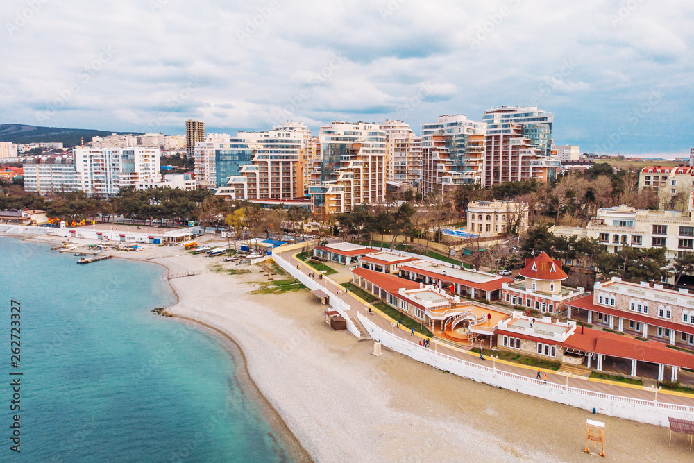 Aerial view of new modern buildings at sea coastline near sand beach, resort on black sea for summer tourism and vacation