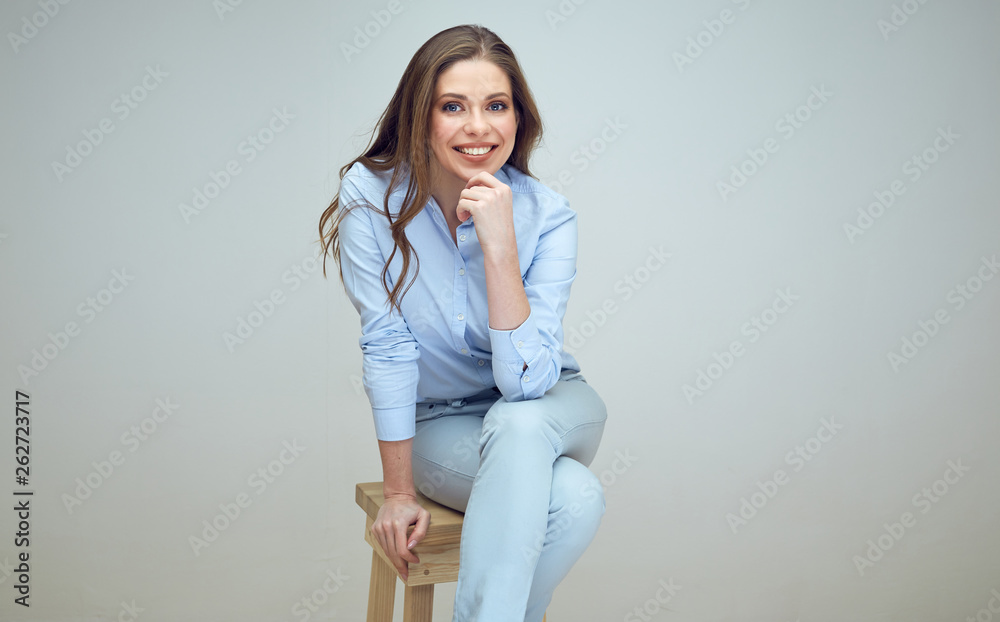happy woman sits on stool in studio. happy woman sits on stool in studio.