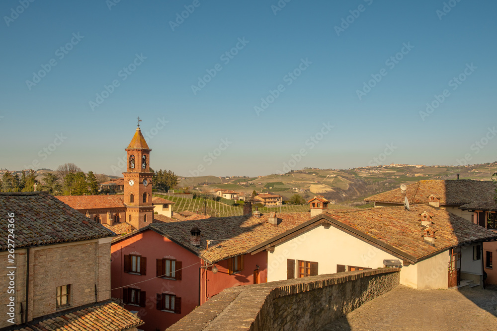 High angle view of the ancient village of Serralunga d'Alba, one of the most beautiful and historically intact villages of the Langhe in Piedmont, surrounded by the hills of Barolo vineyards, Italy
