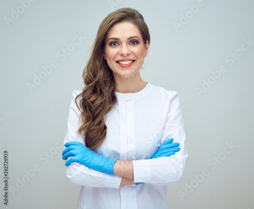 portrait of smiling beautiful woman doctor wearing gloves.