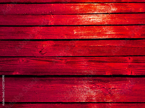 Bright red fence. Orange color fence boards.