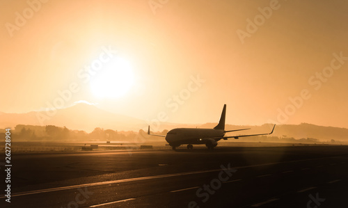 Passenger airplane on the evening, sunset background.