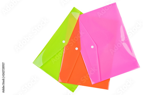 three multicolored plastic folders for documents, laid out on a white background, office concept, isolate