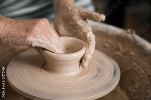Women's hands and potter's wheel