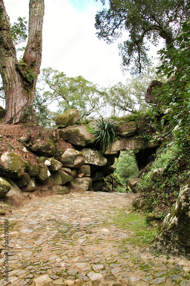Stone arch with rocks in a Leafy garden in Sintra Stone arch with rocks in a Leafy garden in Sintra