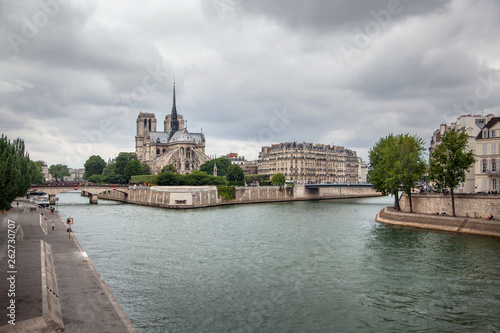 Notre Dame de Paris Cathedral (eastern facade with a spire on the roof) and river Seine in Paris (France, Europe)